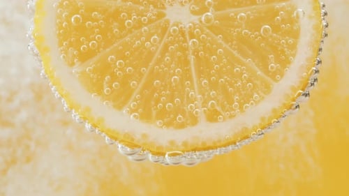 Refreshing Lemon Slice with Bubbles on Yellow