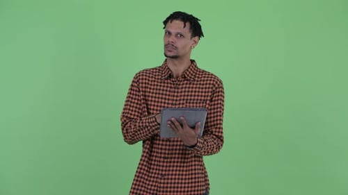 Man Uses Tablet Against Green Screen
