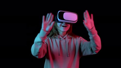 Young Woman Using Virtual Reality Headset with Neon Lights