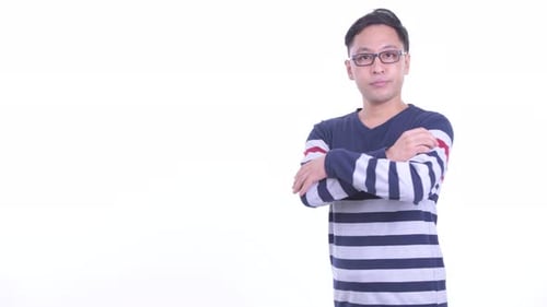 Profile View of Happy Japanese Hipster Man Smiling with Arms Crossed
