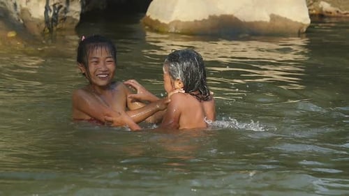Poor Kids Playing In A River
