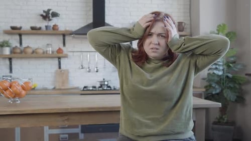 Woman Massaging Temples To Relieve Headache