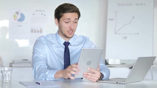 Young Adult Man on Video Call With Tablet