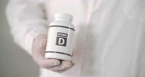 A Big Box of Vitamin D in Doctor's Hand
