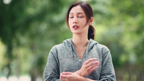 Happy young asian sport woman stand with confidence after exercise outdoors.