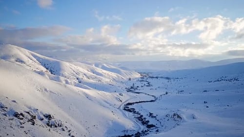 Snowy Mountain Valley Road in Winter Landscape