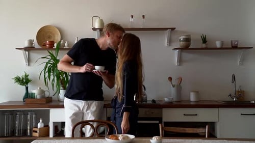 Loving Couple Share a Kiss in Modern Kitchen