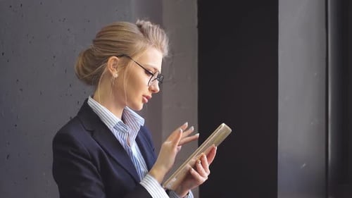 Businesswoman Using Tablet in Modern Office Environment