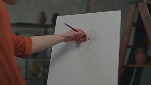 Artist Sketching on Canvas with Pencil in Studio