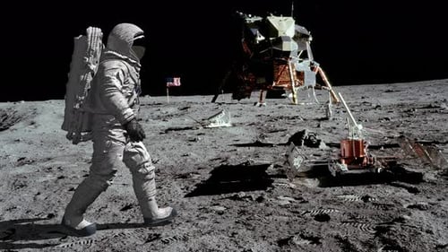 Astronaut Walks on Moon Surface with Lunar Lander and Flag