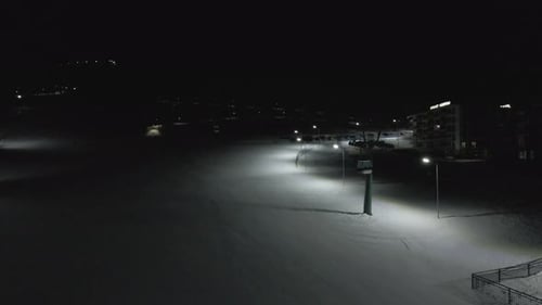 Flying at night over rope-way with gondolas at mountain resort Crystal Park in Bakuriani.