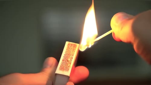Close Up of a Person Lighting a Match