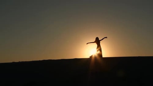 Girl Cute Performs Beautiful Belly Dance on Sunset Background, Silhouette