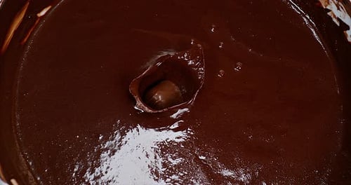 Chocolate Ball Splashes into Rich Batter Close Up