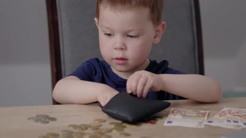 Baby Boy Kid Putting Euro Money Coins Into Black Purse Wallet Savings Education