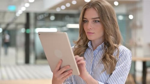 Portrait of Focused Businesswoman Using Digital Tablet