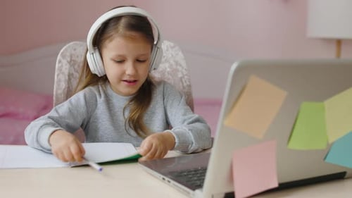 Young Girl Attending School Online with Laptop