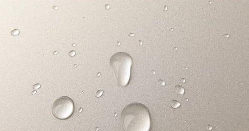 Abstract water drops on grey silver background, macro