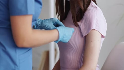 Nurse Administering Injection in Hospital Setting