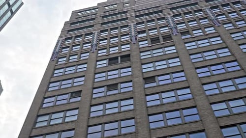 Passing New York Buildings Under Cloudy Sky