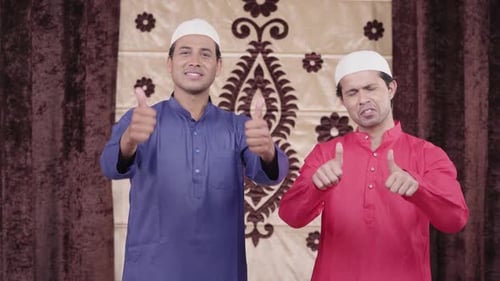 Two Men Wearing Tunics Giving Thumbs Up