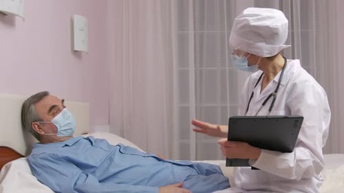 Doctor Consulting with Patient in Hospital Room