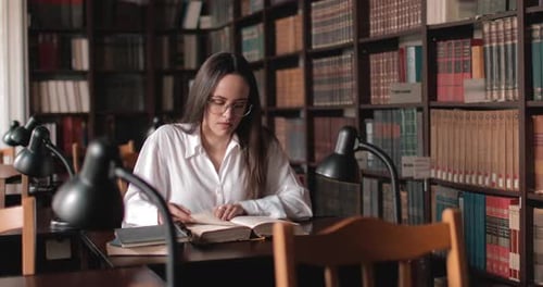 Girl Reading Book in Library