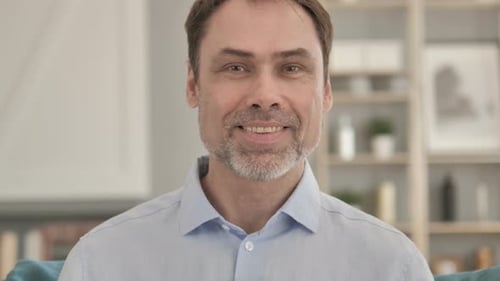 Friendly Man Waving Hello Indoors