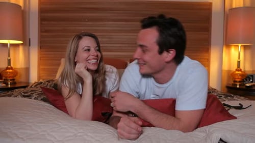 Couple laying on bed together