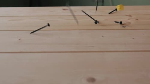 A Lot of Nails Screws and Selftapping Screws Fall on Top of the Wooden Surface