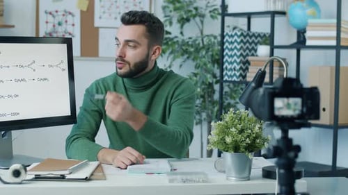 Young Scientist Recording Video About Chemistry Using Modern Camera in Home Office