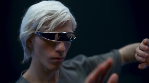 Man Uses Virtual Reality Interface with Futuristic Glasses