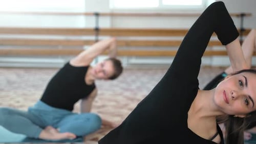 Group of Young Women Making Yoga Stretching in the Fitness Class