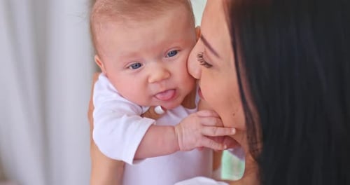 Mother Kissing Adorable Baby in Tender Moment