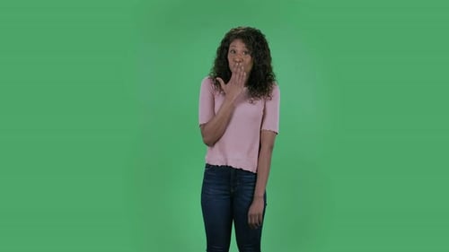 Woman Reacts with Surprise in Front of Green Screen