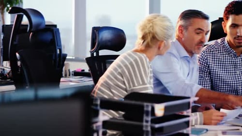 Business Colleagues Collaborating on a Laptop in Office