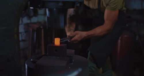 Blacksmith is Working with Automatic Forging Hammer in Smithy Closeup View Prores