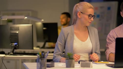 Business Team with Laptop Working at Night Office