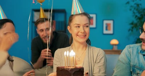 Friends Celebrate Birthday with Cake and Balloons