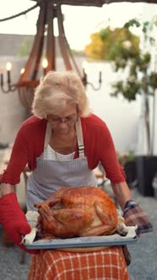 Black Friday Video Footage - Vertical Video Of A Woman Wearing Red Cardigan Holding Roasted Meat