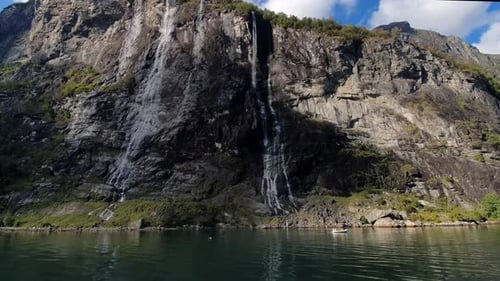 Towering rock walls of the Geiranger Fjord seven sisters Waterfall of Norway