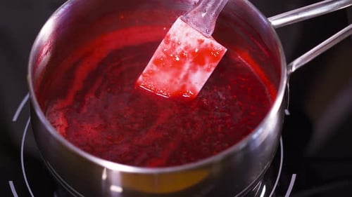 Cooking Red Sauce with Spatula on Stove
