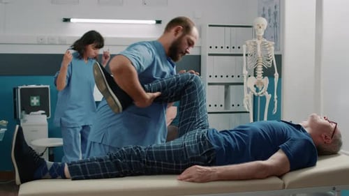 Physical Therapist Assists Patient with Leg Exercises