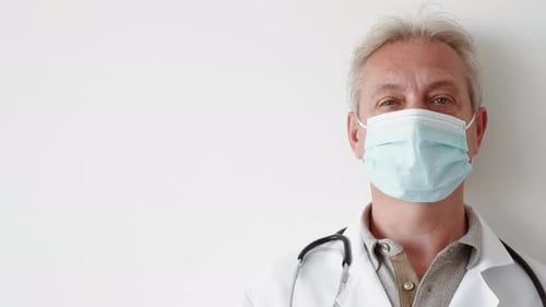 Doctor Wearing Mask and Stethoscope in Hospital Setting