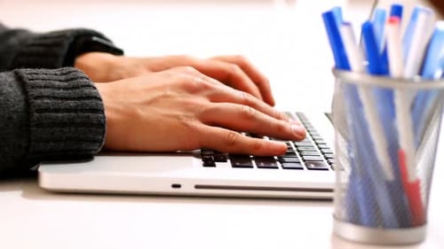 Mid section of male executive using laptop