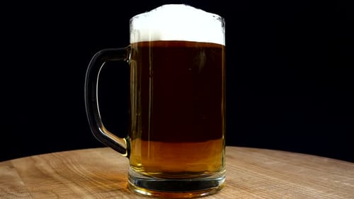 Rotating Close Up of Full Dark Beer Mug