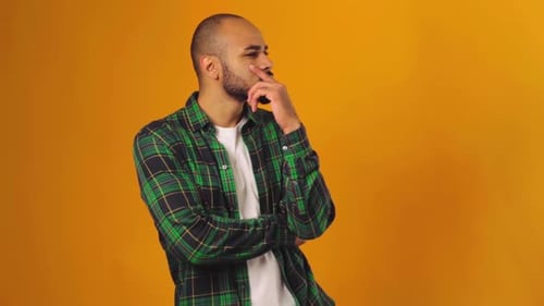 Pensive Young African American Guy Scratching His Chin and Thinking About His Problem