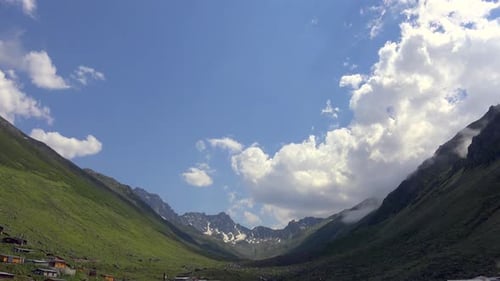 High Snowy Mountains on the Background of Glacial U Valley and Alpine Meadows