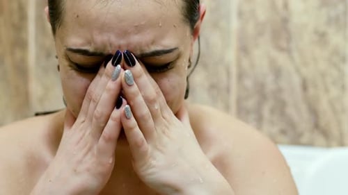 Close-up Upset Wet Woman Crying in the Bathroom After Quarrel