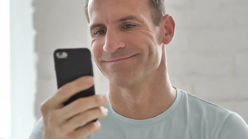 Man Using Smartphone in Office